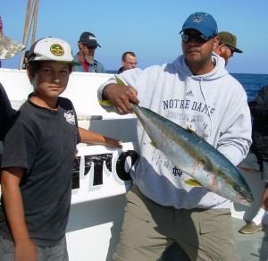 Dad with a yellowtail landed by his son